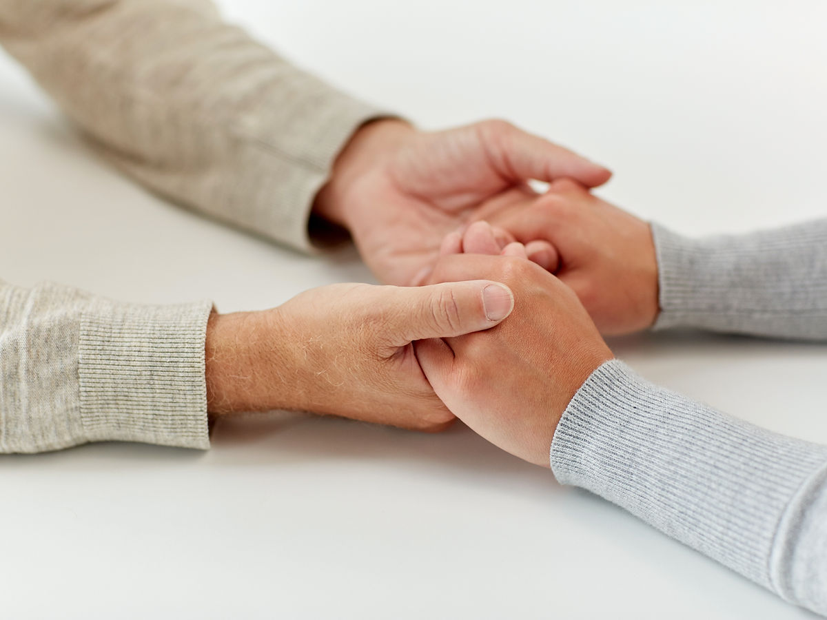 Two people holding hands