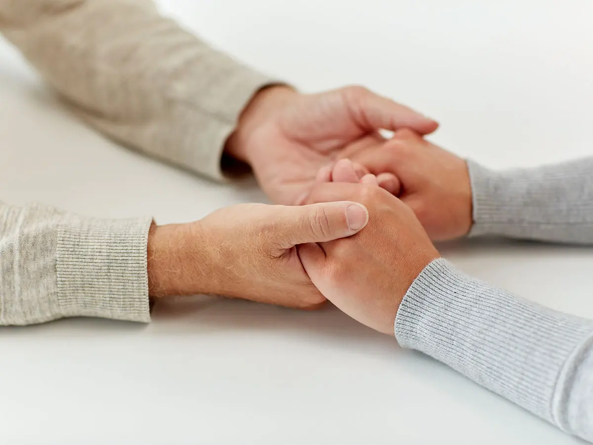 Two people holding hands